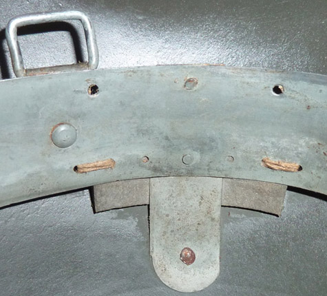 Patte de fixation latérale, détail couture bloc de mousse.